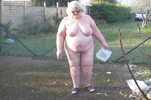 Dikke oma voert de kippen naakt